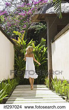 Stock Photo - woman on a garden 
walkway. fotosearch 
- search stock 
photos, pictures, 
images, and photo 
clipart