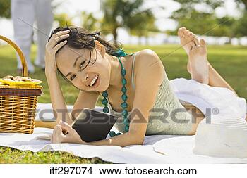 Stock Photo - woman reading 
and picnicking. 
fotosearch - search 
stock photos, 
pictures, images, 
and photo clipart
