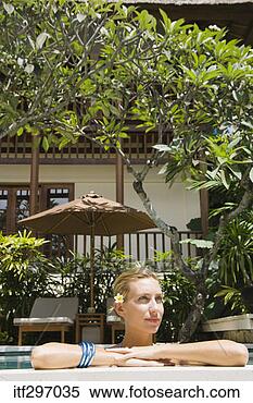 Stock Image - woman relaxing 
in a pool. fotosearch 
- search stock 
photos, pictures, 
images, and photo 
clipart