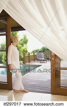 Picture - woman standing 
in a doorway. 
fotosearch - search 
stock photos, 
pictures, images, 
and photo clipart