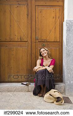 Stock Photo - woman sitting 
at door. fotosearch 
- search stock 
photos, pictures, 
images, and photo 
clipart