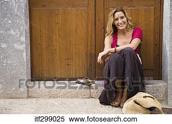Stock Image - woman sitting 
on step. fotosearch 
- search stock 
photos, pictures, 
images, and photo 
clipart