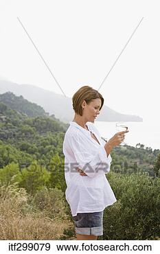 Stock Photograph - woman standing 
with picturesque 
landscape. fotosearch 
- search stock 
photos, pictures, 
images, and photo 
clipart