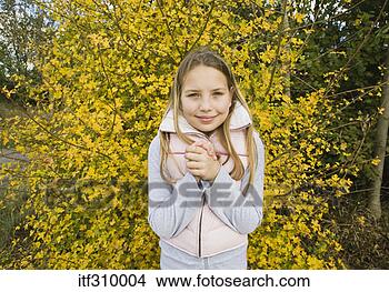 Stock Photo - girl by bush in 
autumn. fotosearch 
- search stock 
photos, pictures, 
images, and photo 
clipart