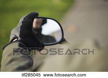 Stock Image - adjusting rearview 
mirror. fotosearch 
- search stock 
photos, pictures, 
images, and photo 
clipart