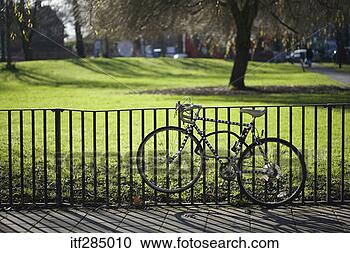 Stock Photography - bike secured to 
fence. fotosearch 
- search stock 
photos, pictures, 
images, and photo 
clipart