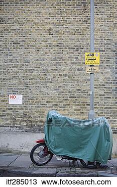 Stock Photo - covered scooter 
secured to pole. 
fotosearch - search 
stock photos, 
pictures, images, 
and photo clipart