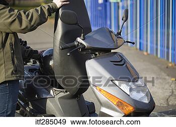 Stock Photograph - putting helmet 
in scooter compartment. 
fotosearch - search 
stock photos, 
pictures, images, 
and photo clipart