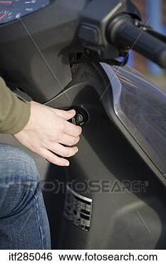 Stock Photo - turning key in 
ignition on motorized 
scooter. fotosearch 
- search stock 
photos, pictures, 
images, and photo 
clipart