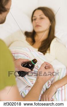 Stock Photo - man giving sick 
woman medicine. 
fotosearch - search 
stock photos, 
pictures, images, 
and photo clipart