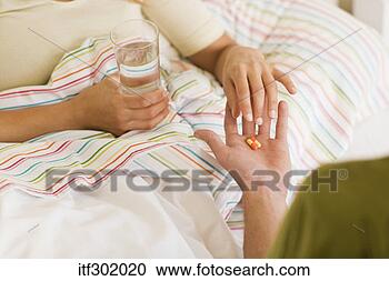 Stock Photography - man giving woman 
medicine. fotosearch 
- search stock 
photos, pictures, 
images, and photo 
clipart