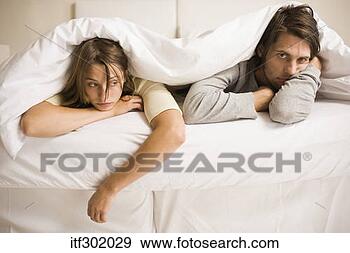 Stock Photograph - sick couple resting 
in bed. fotosearch 
- search stock 
photos, pictures, 
images, and photo 
clipart