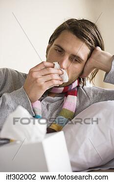Stock Photo - sick man blowing 
nose. fotosearch 
- search stock 
photos, pictures, 
images, and photo 
clipart