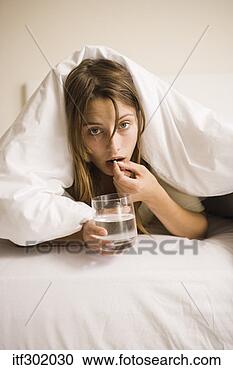 Stock Photography - sick woman in 
bed with medicine. 
fotosearch - search 
stock photos, 
pictures, images, 
and photo clipart