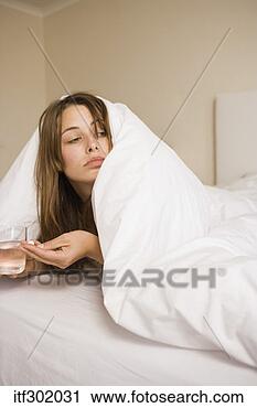 Stock Photography - sick woman in 
bed with medicine. 
fotosearch - search 
stock photos, 
pictures, images, 
and photo clipart