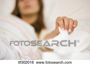 Stock Photo - sick woman reaching 
for tissue. fotosearch 
- search stock 
photos, pictures, 
images, and photo 
clipart