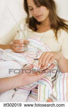 Stock Photograph - sick woman taking 
medicine. fotosearch 
- search stock 
photos, pictures, 
images, and photo 
clipart
