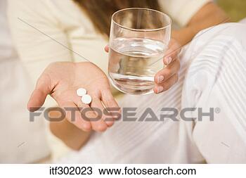 Stock Photo - woman holding 
medicine and water. 
fotosearch - search 
stock photos, 
pictures, images, 
and photo clipart