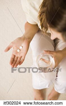 Stock Photo - woman holding 
medicine and water. 
fotosearch - search 
stock photos, 
pictures, images, 
and photo clipart