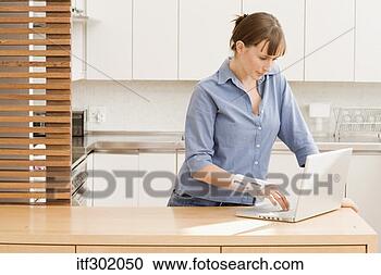 Stock Photography - woman in wrist 
brace using laptop. 
fotosearch - search 
stock photos, 
pictures, images, 
and photo clipart