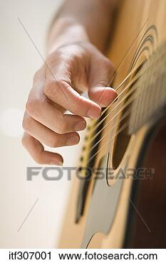 Stock Photography - hand playing acoustic 
guitar. fotosearch 
- search stock 
photos, pictures, 
images, and photo 
clipart