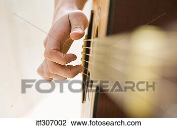 Stock Photo - hand playing acoustic 
guitar. fotosearch 
- search stock 
photos, pictures, 
images, and photo 
clipart