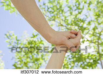 Stock Photo - hands clasped 
with foliage. 
fotosearch - search 
stock photos, 
pictures, images, 
and photo clipart