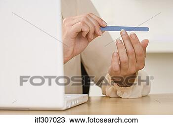 Stock Photo - hands filing nails 
with laptop. fotosearch 
- search stock 
photos, pictures, 
images, and photo 
clipart