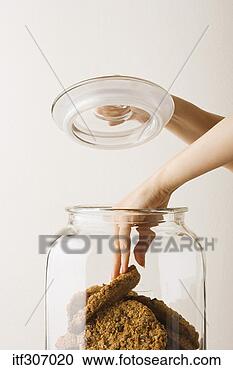 Stock Photography - person taking 
cookie out of 
jar. fotosearch 
- search stock 
photos, pictures, 
images, and photo 
clipart