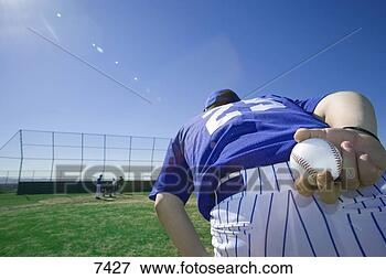Picture - baseball pitcher, 
 in blue uniform, 
 preparing to 
throw ball during. 
fotosearch - search 
stock photos, 
pictures, images, 
and photo clipart