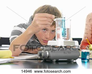 Stock Photo - boy (12-14) experimenting 
in science class. 
fotosearch - search 
stock photos, 
pictures, images, 
and photo clipart