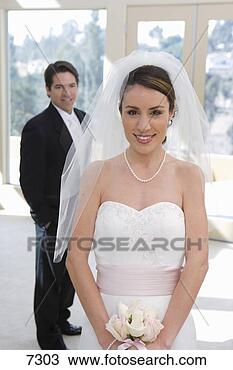 Stock Photo - bride and groom 
posing at wedding, 
 focus on bride 
in wedding dress. 
fotosearch - search 
stock photos, 
pictures, images, 
and photo clipart