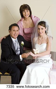 Stock Image - bride sitting 
with parents on 
bench at wedding, 
 father and bride. 
fotosearch - search 
stock photos, 
pictures, images, 
and photo clipart