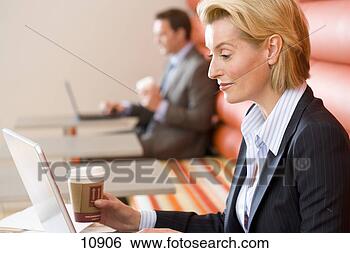 Stock Photo - businesswoman 
with disposable 
cup using laptop 
computer in cafe. 
fotosearch - search 
stock photos, 
pictures, images, 
and photo clipart