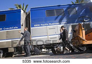 Stock Image - four business 
people walking 
along railway 
platform beside 
stationary. fotosearch 
- search stock 
photos, pictures, 
images, and photo 
clipart