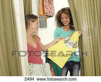 Stock Photo - two teenage girls 
(15-17) trying 
on new clothes 
in fitting room. 
fotosearch - search 
stock photos, 
pictures, images, 
and photo clipart