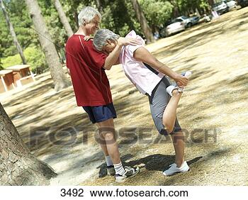 Stock Photo - active senior 
couple in sportswear 
warming up,  woman 
stretching leg. 
fotosearch - search 
stock photos, 
pictures, images, 
and photo clipart