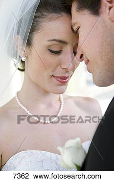 Stock Photo - affectionate bride 
and groom standing 
face to face at 
wedding. fotosearch 
- search stock 
photos, pictures, 
images, and photo 
clipart