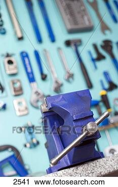 Stock Photography - blue vice in front 
of display rack 
in tool shop, 
 focus on. fotosearch 
- search stock 
photos, pictures, 
images, and photo 
clipart