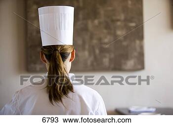 Stock Photo - female chef,  
with brown hair 
in ponytail,  
standing in restaurant. 
fotosearch - search 
stock photos, 
pictures, images, 
and photo clipart