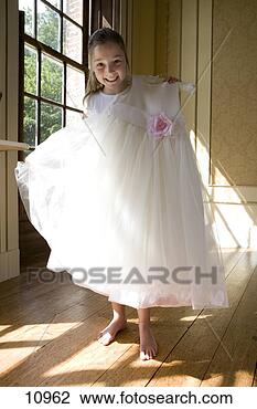 Stock Photo - girl (10-12) holding 
up flower girl 
dress, smiling, 
portrait. fotosearch 
- search stock 
photos, pictures, 
images, and photo 
clipart