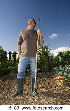 Stock Photograph - man with garden 
hoe in garden. 
fotosearch - search 
stock photos, 
pictures, images, 
and photo clipart