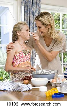 Stock Photo - mother and daughter 
(8-10) baking, 
 mother touching 
daughter's nose. 
fotosearch - search 
stock photos, 
pictures, images, 
and photo clipart