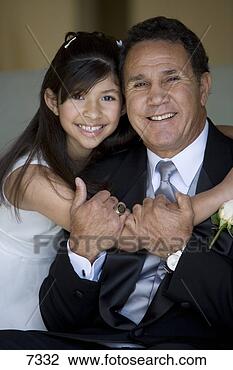 Stock Photo - senior man embracing 
granddaughter 
(8-10),  girl 
wearing. fotosearch 
- search stock 
photos, pictures, 
images, and photo 
clipart