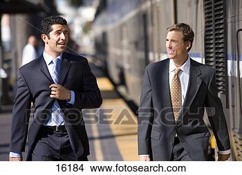 Stock Photo - two businessmen 
walking to train 
at train station. 
fotosearch - search 
stock photos, 
pictures, images, 
and photo clipart