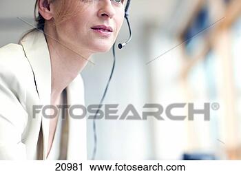 Stock Photography - cropped portrait 
of mature woman 
wearing headset. 
fotosearch - search 
stock photos, 
pictures, images, 
and photo clipart