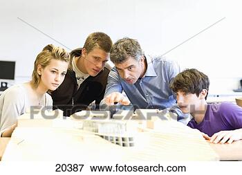 Picture - mature man and 
teens gathered 
around an architectural 
model. fotosearch 
- search stock 
photos, pictures, 
images, and photo 
clipart