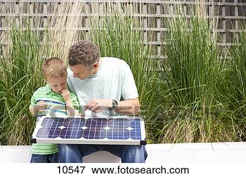 Picture - father showing 
son (4-6) solar 
panel outdoors. 
fotosearch - search 
stock photos, 
pictures, images, 
and photo clipart