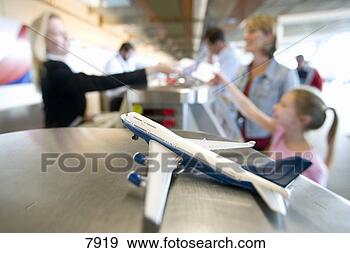 Stock Photograph - mother and daughter 
(7-9) receiving 
ticket from female 
flight. fotosearch 
- search stock 
photos, pictures, 
images, and photo 
clipart