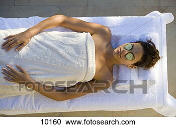 Stock Photography - young woman having 
beauty treatment, 
 cucumber slices 
on eyes. fotosearch 
- search stock 
photos, pictures, 
images, and photo 
clipart